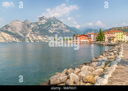 Standing by the lakeside looking north to the small town of Torbole. Stock Photo