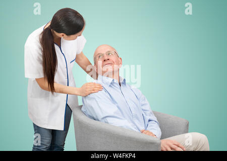Smiling nurse and old senior man patient. Care for older people concept Stock Photo