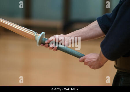 Young man practicing Kendo with wooden sword. Stock Photo