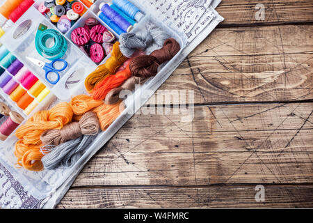 Sewing tool for needlework. colored threads, centimeter and buttons with a pair of scissors on the table.Copy space Stock Photo