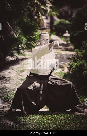 Young serious man aikido master in traditional costume Stock Photo