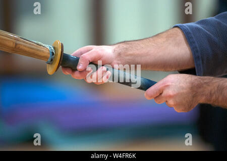 Young man practicing Kendo with wooden sword. Stock Photo