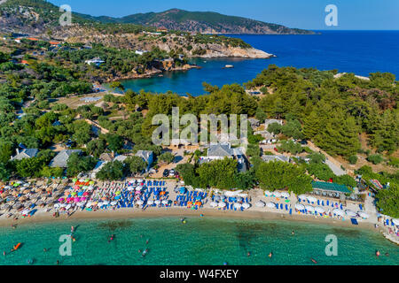 Aerial View of the Aliki Beach with colorful umbrellas, at Thassos island, Greece. swimming people in sea Stock Photo