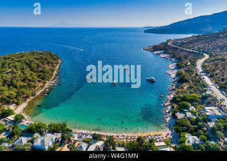 Aerial View of the Aliki Beach with colorful umbrellas, at Thassos island, Greece. swimming people in sea Stock Photo