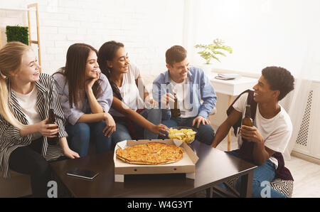 Happy african american friends eating pizza at home Stock Photo by  Prostock-studio