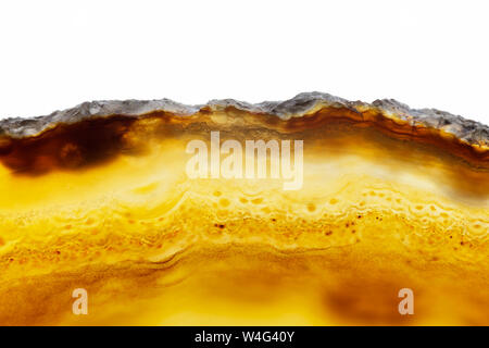Abstract background, brown and orange agate slice mineral cross section isolated on white background Stock Photo