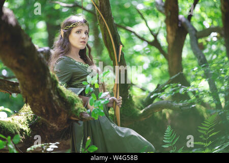 Elf archer with a bow in the forest Stock Photo