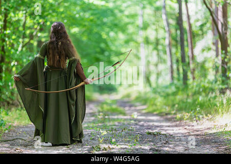 Elf archer from behind in the woods Stock Photo