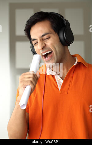 Man wearing headphones and singing Stock Photo