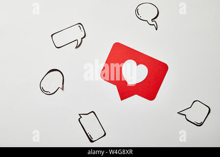 red like sign card with thought and speech bubbles on white surface Stock Photo