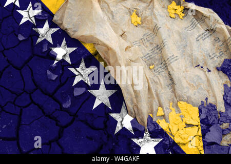 The flag of Bosnia and Herzegovina, the flag is depicted on cracked earth. Ecology concept with environmental pollution from household and industrial Stock Photo