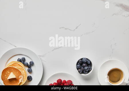 top view of tasty pancakes with berries and cup of coffee Stock Photo