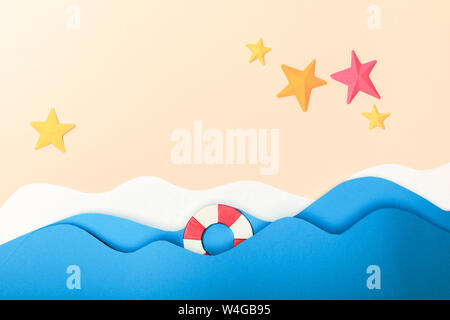top view of paper beach with starfishes on sand near sea with waves and lifebuoy Stock Photo