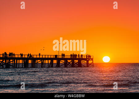 Semaphore Beach  jetty with people at sunset, South Australia Stock Photo