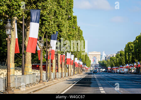 For Bastille Day the avenue des Champs-Elysees in Paris, France, is decked with large french flags along its whole length up to the Arc de Triomphe. Stock Photo