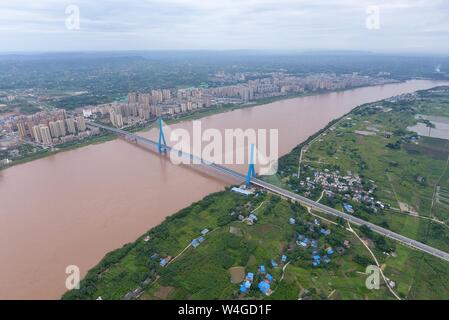 Yibin. 30th Jan, 2019. Aerial photo taken on July 23, 2019 shows Nanxi Xianyuan Yangtze River Bridge in Nanxi District of Yibin City, southwest China's Sichuan Province. The bridge opened to the public traffic on Jan. 30, 2019, by which local residents no longer need a ferry to cross the river. Credit: Liu Kun/Xinhua/Alamy Live News Stock Photo