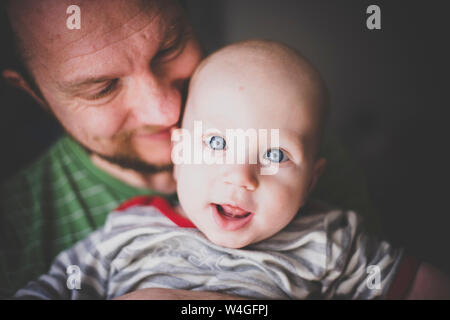Portrait of father holding his baby boy Stock Photo