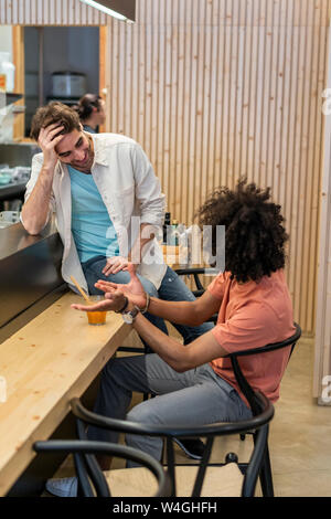 Two men talking in a bar Stock Photo