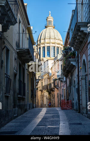 View from an old town alley to Duomo di San Giorgio, Ragusa Ibla, Ragusa, Sicily, Italy Stock Photo