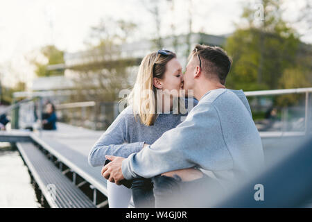 Young couple kissing on jetty at Lake Zurich, Zurich, Switzerland Stock Photo
