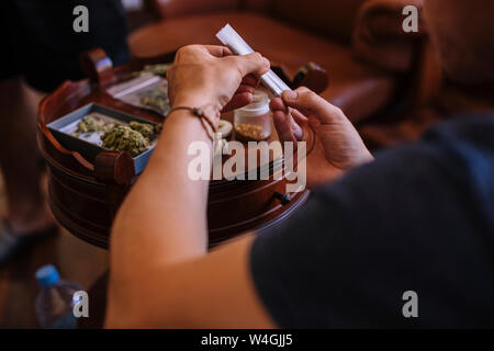 Close-up of a hands rolling a joint of marijuana Stock Photo