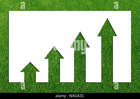 Business graph charting upwards on grass Stock Photo