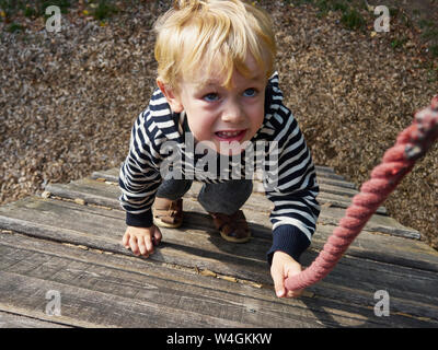 Portrait of little boy on climbing frame Stock Photo