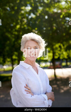 Portrait of mature woman, smiling, outdoors Stock Photo - Alamy