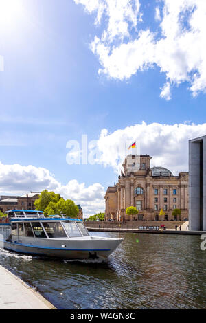 View to Reichstag with tourboat on Spree River in the foreground, Berlin, Germany Stock Photo