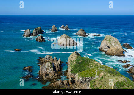 View from the Nugget Point Lighthouse in the turquoise waters with huge rocks, The Catlins, South Island, New Zealand Stock Photo