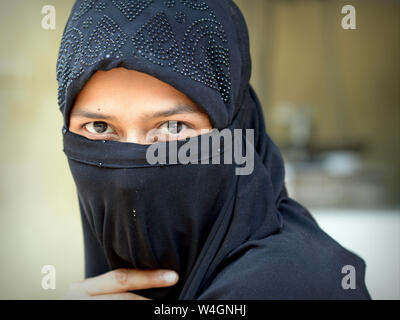 Beautiful islamic woman posing with a traditional hijab isolated on a ...