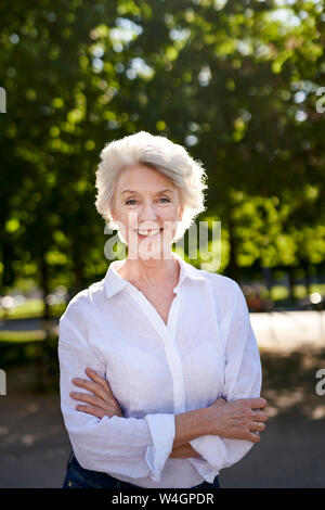 Portrait of mature woman smiling outdoors Stock Photo - Alamy