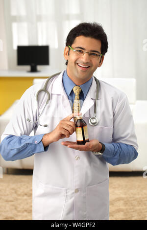 Male doctor holding a bottle of medicine Stock Photo