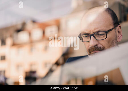 Portrait of serious mature businessman in a cafe Stock Photo