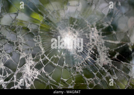 Broken smartphone screen with natural background. Cracked screen phone Stock Photo