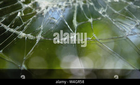 Broken smartphone screen with natural background. Cracked screen phone. Stock Photo