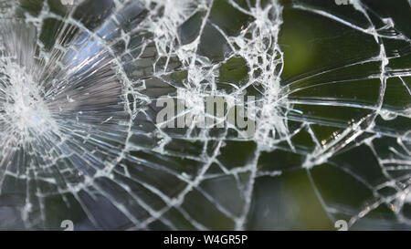Broken smartphone screen with natural background. Cracked screen phone Stock Photo
