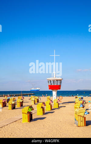 View to beach with hooded beach chairs and attendant's tower, Luebeck Travemuende, Germany Stock Photo