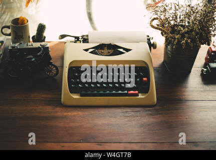 old typewriter on old wooden table Stock Photo