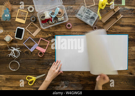 Top view of woman's hands preparing a scrapbook Stock Photo