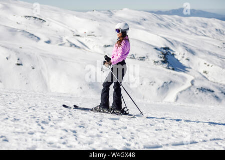 Woman skiing on snow-covered landscape in Sierra Nevada, Andalusia, Spain Stock Photo