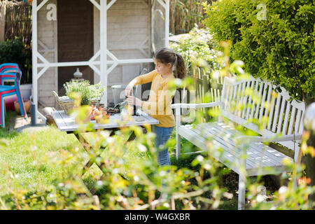 Girl gardening on garden table Stock Photo