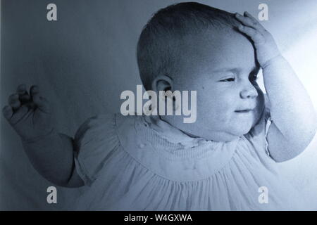 Fine black and white art photography from the 1970s of a baby having an aha moment.  I should have known that.  I just got it. Stock Photo