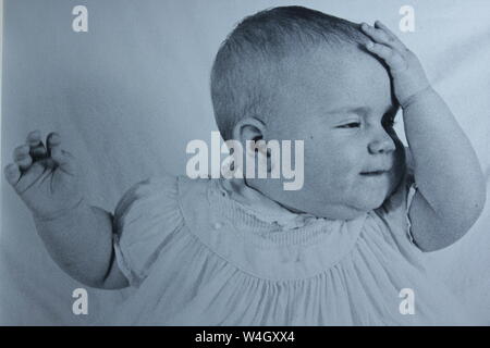 Fine black and white art photography from the 1970s of a baby having an aha moment.  I should have known that.  I just got it. Stock Photo