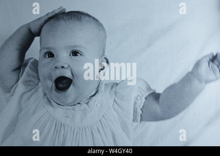 Fine black and white art photography from the 1970s of a baby having an aha moment.  I should have known that.  I just got it. Stock Photo