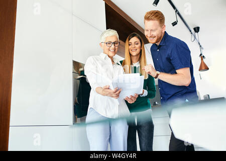 Couple shopping for a new kitchen in showroom looking at papers Stock Photo