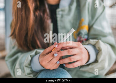 Woman's hands rolling a Marihuana joint, close-up Stock Photo