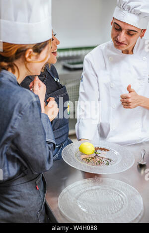 Junior chef showing his prepaired dessert on plate Stock Photo