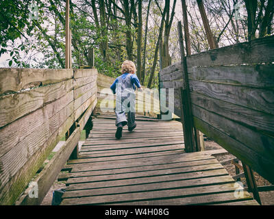 Back view of running little boy on playground Stock Photo