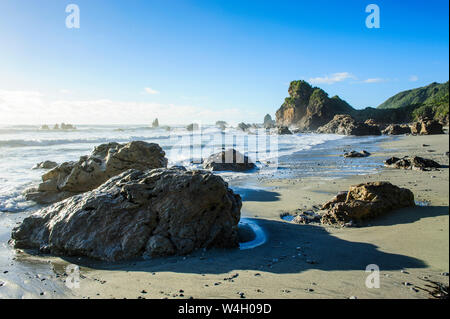 Boulders on a beach on the wild west coast of South Island between Greymouth and Westport, South island, New Zealand Stock Photo